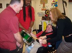 Washington Center students enjoyed percussion instruction by parent John Dalby (left) as Robert Poole (Para-educator) and Music Teacher Julie Dail assist student Davis Dalby in playing the drums.