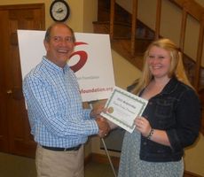 Payton Donlan Drummond, a graduate of Riverside High School, was awarded a $500 grant for continuing studies in the nursing program at Greenville Technical College. Education Board Director David Dolge presented the award.