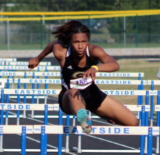 Greer High School sophomore Kaiya Bradford clears a hurdle to finish the 100-meter race at the Greenville County Track and Field Championships Wednesday night at Eastside High School.
 
.
.