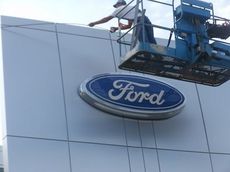 A worker is putting the signage on the front of D&D Ford. The new showroom and service facility opens Monday at 8 a.m.
 