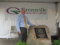 Greenville Tech President Keith Miller stands next to the monument recognizing the 50th anniversary of Greenville Tech.
