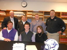 Reese Hannon is the center of attention during his signing a football letter-of-intent to play football at Furman University. Flanking Reese is his father, Ben, and mother, Linda. Left to right in back are Principal Marion Waters, offensive coordinator and quarterbacks Jay Abercrombie, Luke Hannon and Greer Head Coach Will Young. The signing took place at Greer High School.