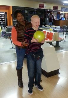 Washington Center student Adorrious Dunlap is assisted by Para-Educator Karimah Morris during a community-based Instructional bowling trip.