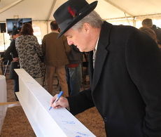 Greer Mayor Rick Danner signs the symbolic topping out beam.
 
