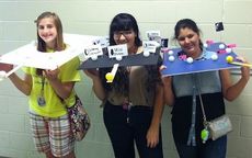 Makenzie Stewart, Melissa Medina, and Nicole Kaminski model their moon phase project which they donated to Mrs. Crystal Garner’s class to use as a teaching tool for future Riverside Middle School students.
 