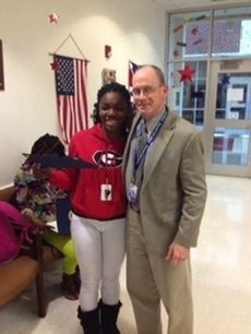 Riverside Principal Andrew Crowley presents Teavonnie Kyeasta Coleman-Blakely the Certificate of Special Congressional Recognition from House of Representatives Congressman Trey Gowdy. 