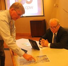 Randy Olson shows CPW Commissioner Perry Williams some infrastructure being put in place during the utility's monthly public meeting.
 