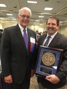 Alan Scheidhauer (right) receives the A. Wade Martin Innovator of the Year award from Darrel Staat, president of the South Carolina Technical College System. 
 
