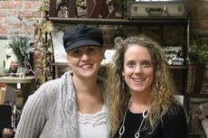 Kendra Glenn, right, and vendor Tracy Brandon get together for a photo today at the Shoppes On Trade. Glenn was explaining plans to add more artisan vendors and a small deli and spa services.