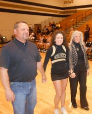Anna Brown, a four-year cheerleader with Greer High School, was recognized for her achievement during Senior Night. Her parents, Mike and Debbie, escorted Anna to midcourt.