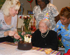 Sarah Jennings, a resident at Oakleaf Village Assisted Living in Greer, admires the cake with the numbered candles signaling how old she is. Catherine Gross lit the candles and Charlene Ramsey (right) and Linda Gordon celebrate Jennings’ birthday.