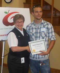 Timothy Bright, a graduate of Greer High School, received a $500 BMW scholarship for continuing studies in welding at Greenville Technical College. Bunny Richardson of BMW presented the grant.