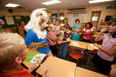 Fifth-graders at Bob Jones Academy, above, and four-graders, below, meet the new mascot during a surprise classroom visit the first day of school.