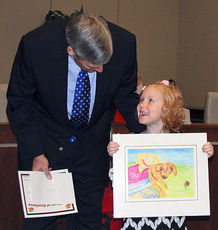 Emmalee Nutter is all smiles as she explains to Mayor Rick Danner her drawing titled My Dog that won first place in her class group in the City of Greer’s “I am thankful for …” contest. The drawings were posted at City Hall preceding the Thanksgiving Holidays.