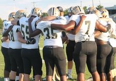 Defensive line coach Raashard Jackson, inside the huddle, challenged his team to 