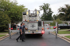 This photo shows how the fire truck, with its outriggers in place, takes up most of the narrow street. If cars are parked on the street, that would cause the firefighters to lose valuable time getting the cars moved out of the way.
