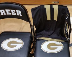 Nathan Moore's home game jersey is draped over a chair along the Greer sideline.
 
