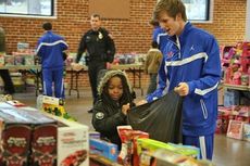Riverside High School boys basketball players spent the day helping children select gifts, size clothes and generally enjoying giving back to the community's youth.