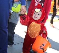 A little Gamecock dressed in red figures to get a lot of candy with the orange pumpkin.
 