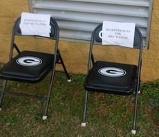 These seats were marked for Marion Waters and his wife. Waters traditionally sits in a folding chair by the field house.