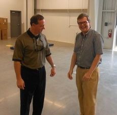 Skip Davenport, President and General Manager of D&D Ford, left, visited the service area at the new site this afternoon. 
