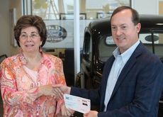 Skip Davenport, president and general manager of D&D Motors, presents a $10,000 donation to Nancy Webb, vice chair board of directors for Daily Bread Ministries.
 