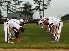 Blue Ridge baseball players warm up to resume play after a 40-minutes lightning delay.
 