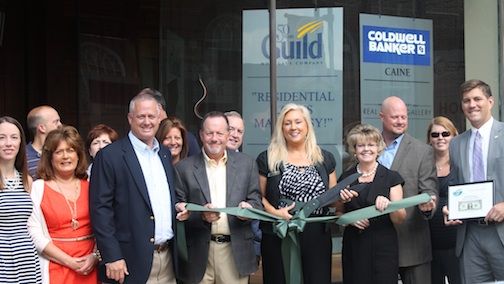 Kristi Farmer, Greer Branch Manager for the Guild Mortgate Company, cuts the ribbon celebrating the company's downtown location.
 
 