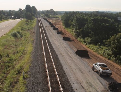 Railroad cross ties are stacked and grading has been completed in preparation for the laying of a second set of Norfolk and Southern tracks on the east end of the Inland Port.