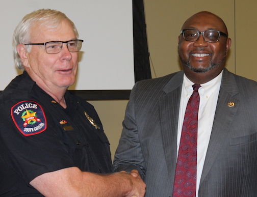 Greer Police Chief Dan Reynolds received recognition for serving as past president with the South Carolina Police Chiefs Association by Kelvin Washington, U.S. Marshal for the District of South Carolina.
 