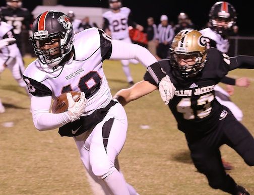 Brian Garrett (18) of Blue Ridge tries to get some distance from a Greer defender.
 