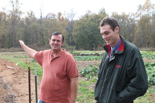 Chad Manaton, left, and Jean-Pierre Wersinger show where a greenhouse is being built on property where they began producing local produce for subscription paying customers.