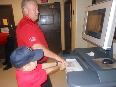 Lt. Jim Holcombe shows Chief Sincavage the fingerprinting process during a tour of the facilities this morning.
 