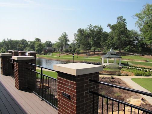 An elevated deck outside the building’s main entrance overlooks the Greer City Park pond and gazebo.