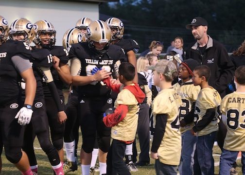 Youth football players sought Greer varsity players' autographs Friday night at Dooley Field. Greer Recreation youth players and cheerleaders were recognized at halfitme.