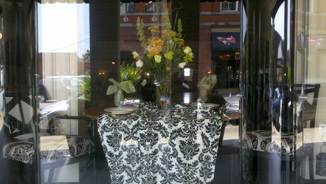 Downtown window shoppers get an idea of Paige's work with this elegant display at Grace Hall.