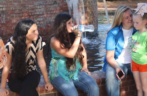 Left to right: Keydria Martinez, Zelena Hull and Anna McCleer take in some shade between performances last Friday.
 