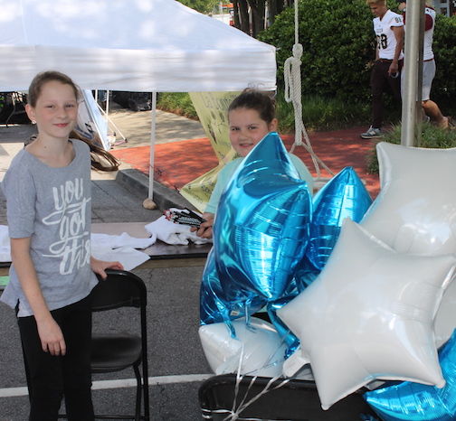 Downtown Greer has been having windy events of late, including three consecutive Farmers Market Thursdays. The girls are anchoring balloons here until reinforcements arrive.
 