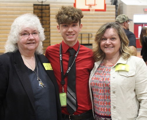 Austin Terault is flanked by his grandmother, Donna Williams, and mother, Paula Terault.
 