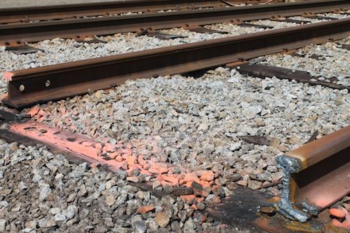 The train tracks are split at a welding point so that they may be lifted without buckling or bending rails still in use.