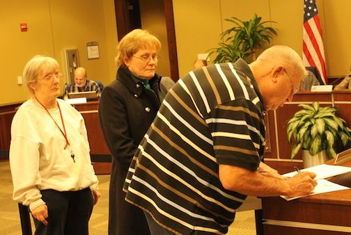 Phil Pickett, Amy Macks and Jan Keith sign in to speak at Monday night's City Planning Commission meeting.