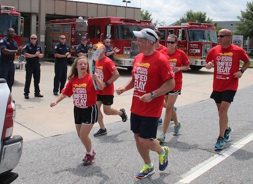 Greer fire department staff applaud the runners passing the station on Poinsett Street.
 