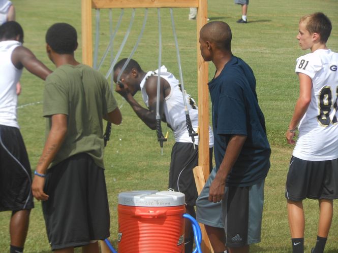Water breaks are welcome during summer practices for players and coaches. Greer coaches provide designated water breaks and encourage players to replinish their liquid throughout the practice.