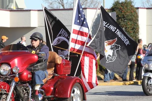 The Patriot Guard, nearly 200 strong, lead the procession to Wood Mortuary.