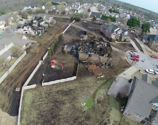 This wide-angle photo shows the house razed by the fire on the right of the three-unit condominium above right.
 