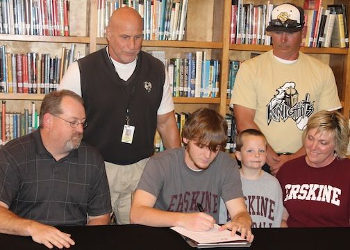 Jake Purvis, center, signs a baseball letter-of-intent with Erskine College while his parents, Rodney, left, and Dana, right, and brother, Ridge, observe. Baseball coaches Bob Massullo and Brian Wortkoetter.