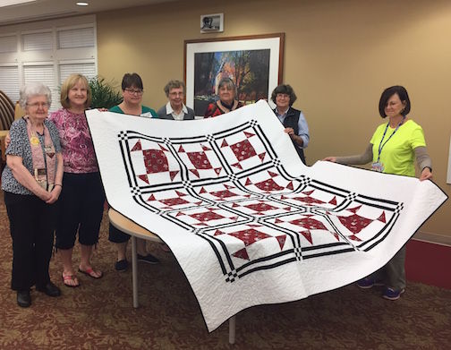 The Peach Patchers Quilt Guild donated a handmade Gamecock quilt to Greer Community Ministries’ Big Thursday event. Quilters from left: Betty Reid, Martha White, Leigh Radlein, Lois Bruckner, Pilar Anderson, Sandy Bridwell, and Joan Gilstrap.
 