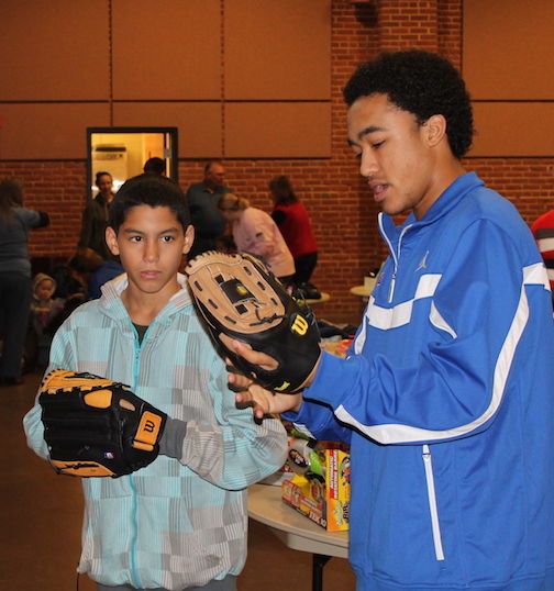Riverside High School boys basketball players traditionally volunteer to help with the Cops for Tots toy distribution.
 
 
