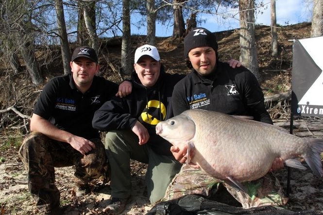 Left to right: Mihai Aciu, Jason Bernhardt and Bogdan Bucur, all from Illinois, celebrate the catch and release of this record-setting 65-pound, 12-ounce carp.
