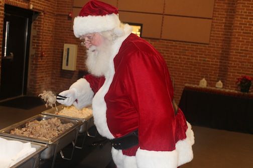 Santa pigs out on barbecue during the dinner with Santa at the Cannon Centre Friday.